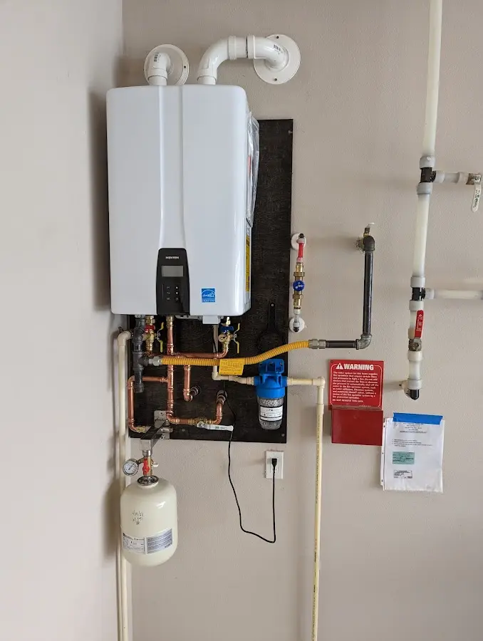 Professional plumber installing copper piping in a Cottonwood Heights home